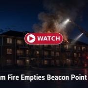 Fostoria News Nighttime fire at Beacon Point building with fire truck and smoke.